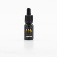 Black dropper bottle with gold label on a white background